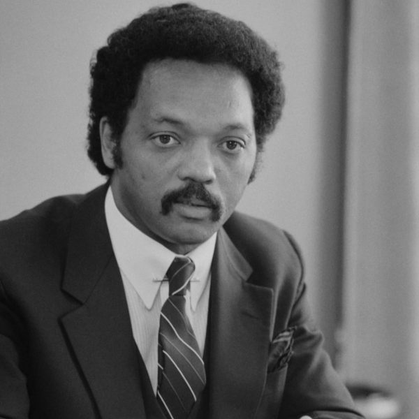 Jesse_Jackson_half-length_portrait_of_Jackson_seated_at_a_table_July_1_1983_edit.jpg